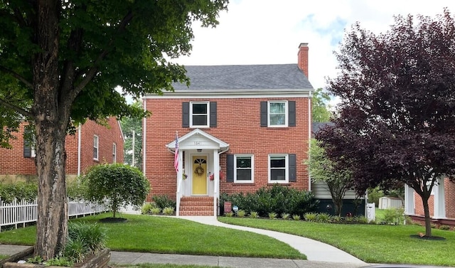 colonial home with a front yard