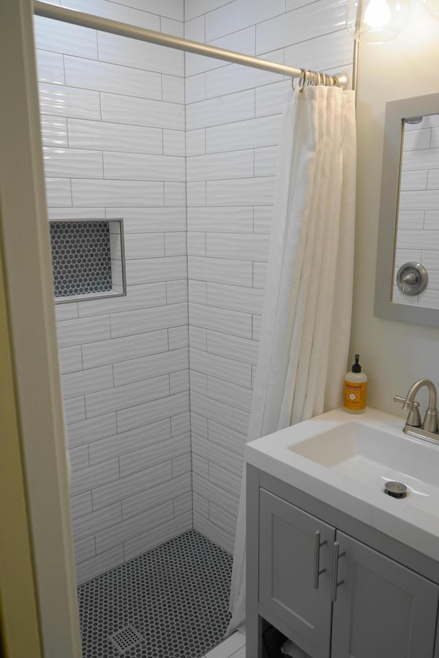 bathroom featuring vanity and curtained shower