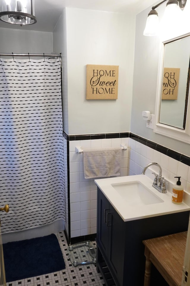 bathroom with vanity, tile patterned floors, tile walls, and a shower with shower curtain