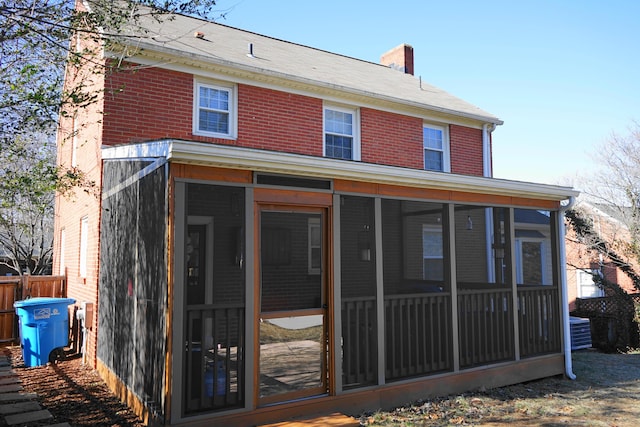 back of house with central AC and a sunroom