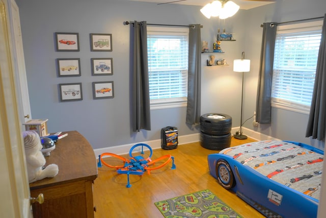 bedroom featuring hardwood / wood-style flooring and ceiling fan