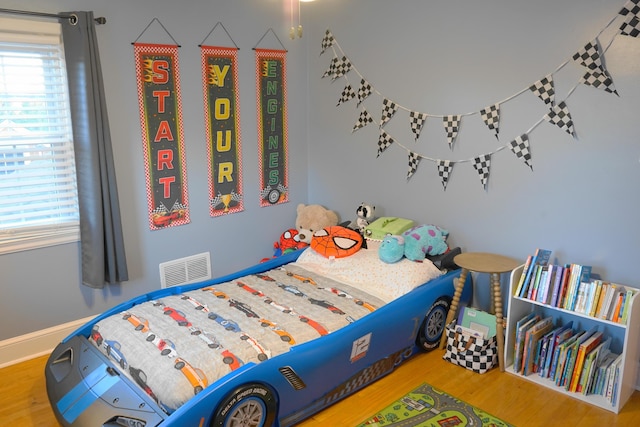 bedroom with hardwood / wood-style floors