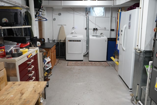 basement featuring white fridge with ice dispenser and independent washer and dryer