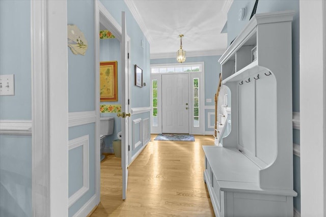 mudroom featuring crown molding and light hardwood / wood-style floors