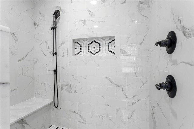 bathroom with tiled shower