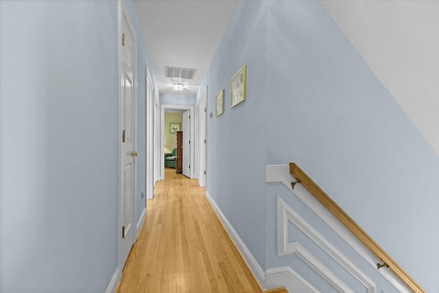 hallway with light hardwood / wood-style floors