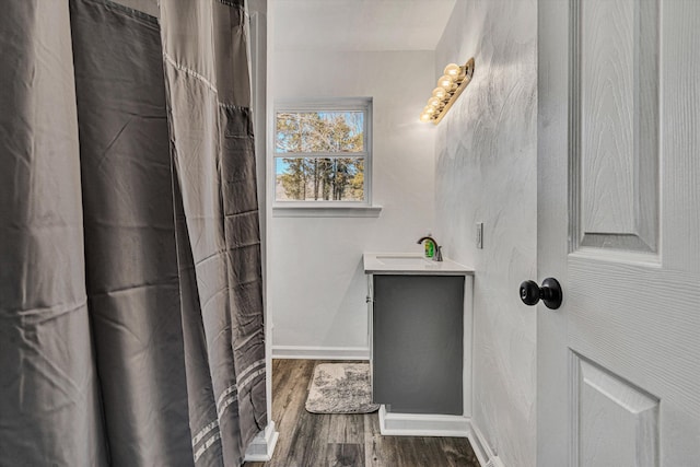 bathroom with vanity and wood-type flooring