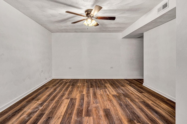 spare room with dark wood-type flooring and ceiling fan