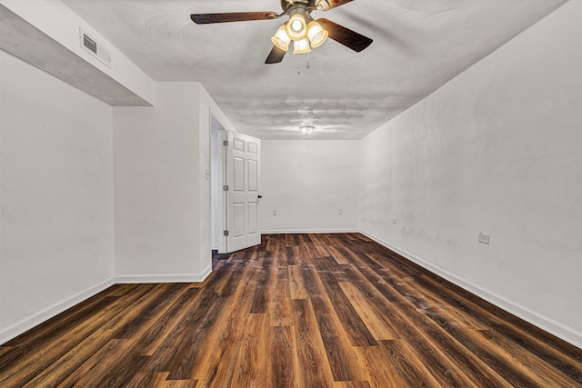 spare room with ceiling fan and dark hardwood / wood-style flooring