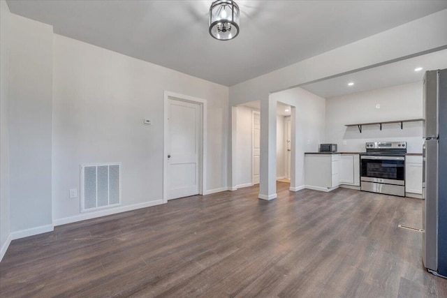 unfurnished living room with dark hardwood / wood-style flooring