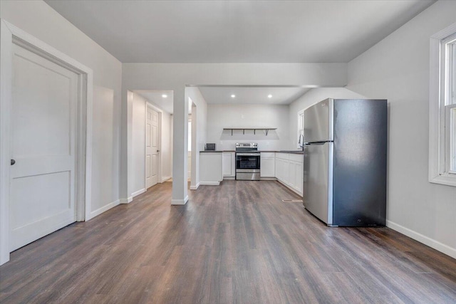 kitchen with white cabinetry, appliances with stainless steel finishes, and dark wood-type flooring