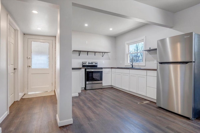 kitchen featuring white cabinetry, appliances with stainless steel finishes, dark wood-type flooring, and sink