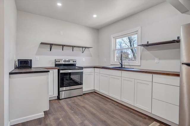 kitchen with white cabinetry, appliances with stainless steel finishes, sink, and dark hardwood / wood-style floors