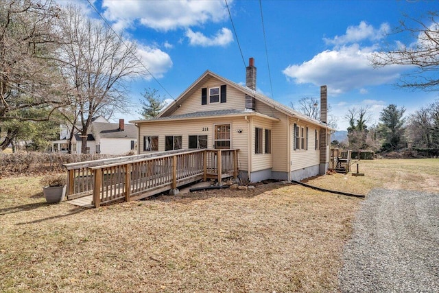 view of front of house featuring a deck and a front lawn