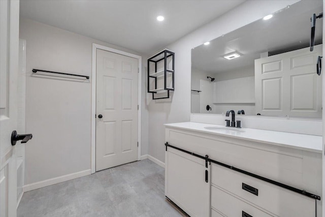 bathroom with walk in shower and vanity