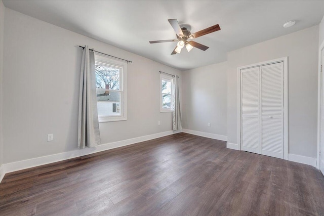 unfurnished bedroom with a closet, dark hardwood / wood-style floors, and ceiling fan