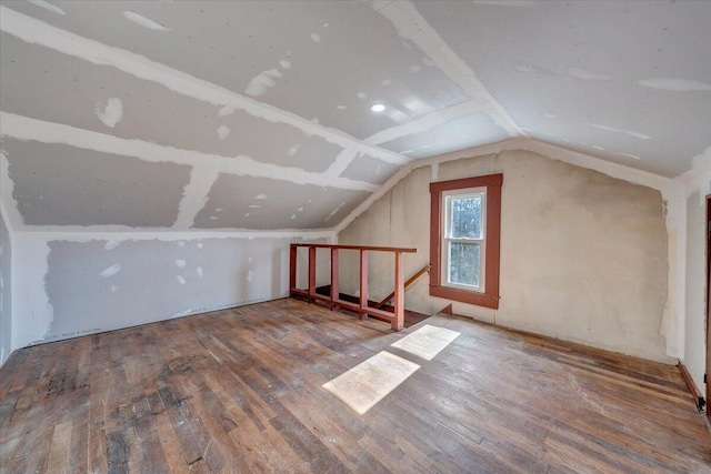 additional living space featuring lofted ceiling and wood-type flooring