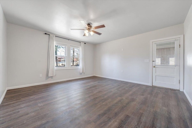 spare room with ceiling fan and dark hardwood / wood-style flooring