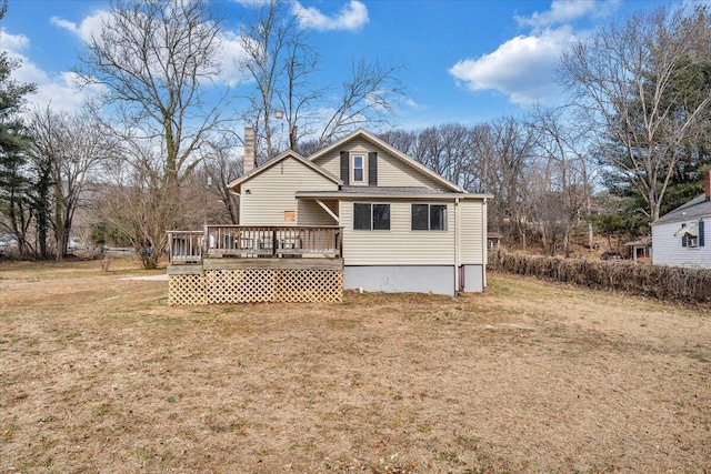 back of property featuring a deck and a lawn