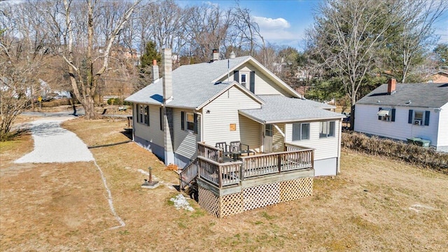 rear view of property with a yard and a deck