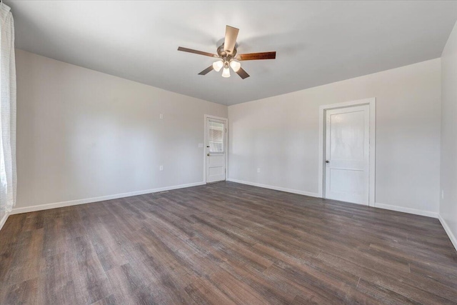 spare room with dark hardwood / wood-style floors and ceiling fan