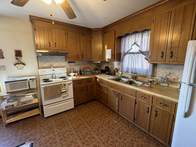 kitchen featuring tasteful backsplash, sink, white appliances, and ceiling fan