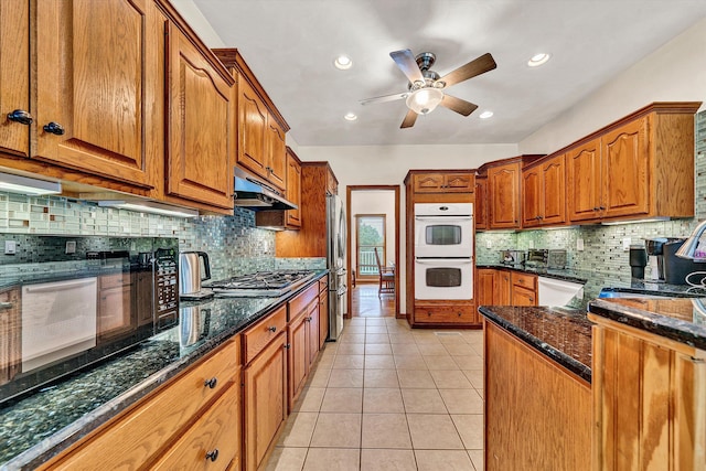 kitchen featuring tasteful backsplash, appliances with stainless steel finishes, light tile patterned floors, and ceiling fan