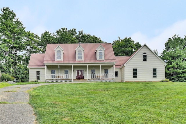 cape cod house with a front lawn and covered porch