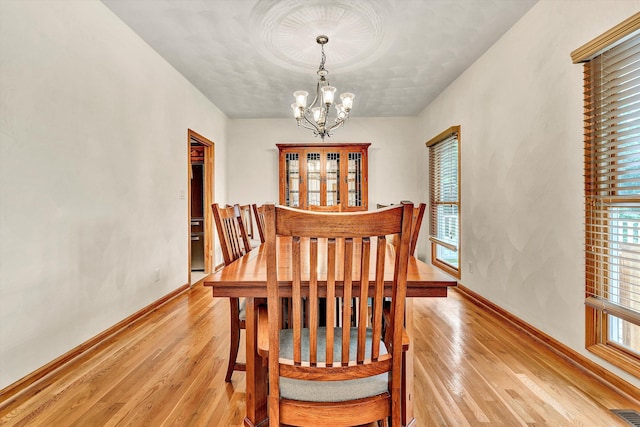 dining room featuring a chandelier and light hardwood / wood-style flooring