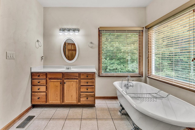 bathroom with tile patterned floors, vanity, and a washtub