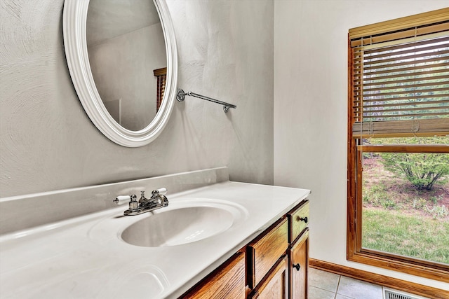 bathroom featuring tile patterned flooring and vanity