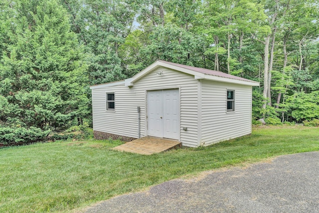 view of outdoor structure featuring a lawn