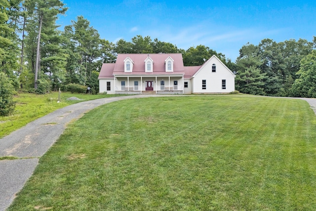 cape cod-style house featuring a front yard and a porch