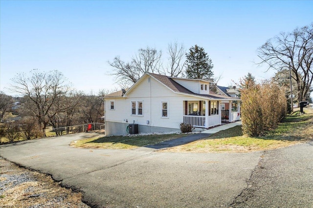 view of side of property with central AC and covered porch