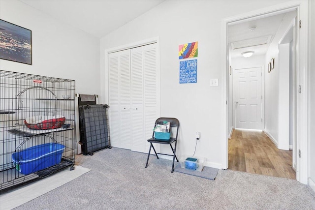 interior space featuring light colored carpet and vaulted ceiling