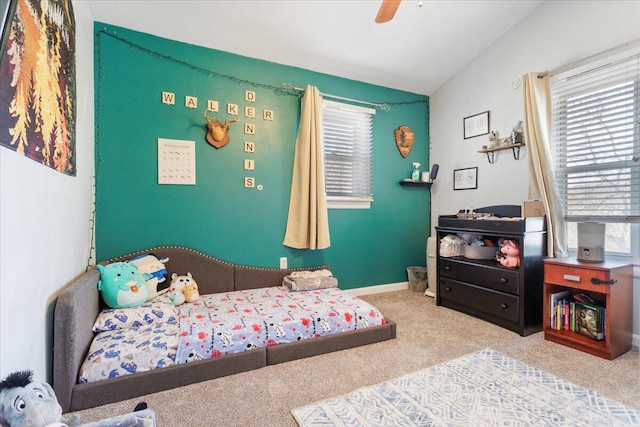 carpeted bedroom with multiple windows, lofted ceiling, and ceiling fan