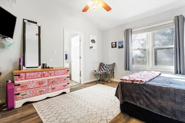 bedroom with vaulted ceiling, ceiling fan, and dark hardwood / wood-style flooring