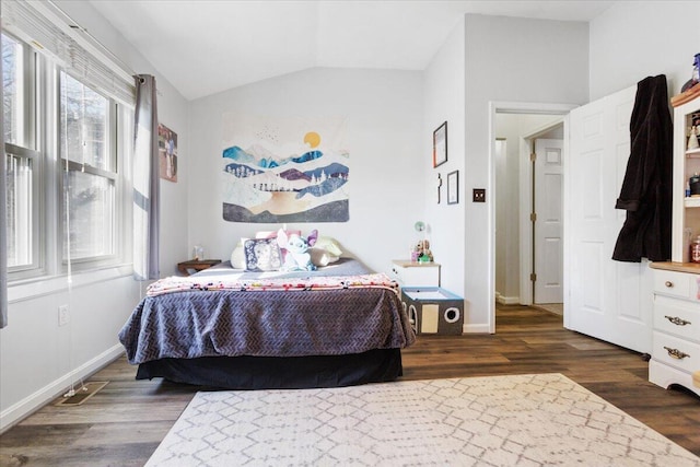 bedroom with lofted ceiling and dark hardwood / wood-style floors