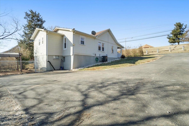 view of side of home featuring central AC