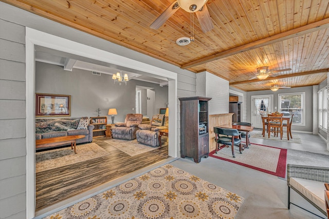 living room featuring ceiling fan with notable chandelier, wooden ceiling, and beamed ceiling