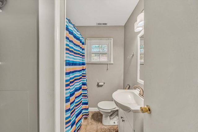 bathroom with vanity, toilet, curtained shower, and tile patterned flooring