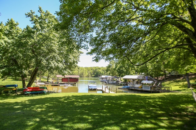 dock area with a water view and a yard