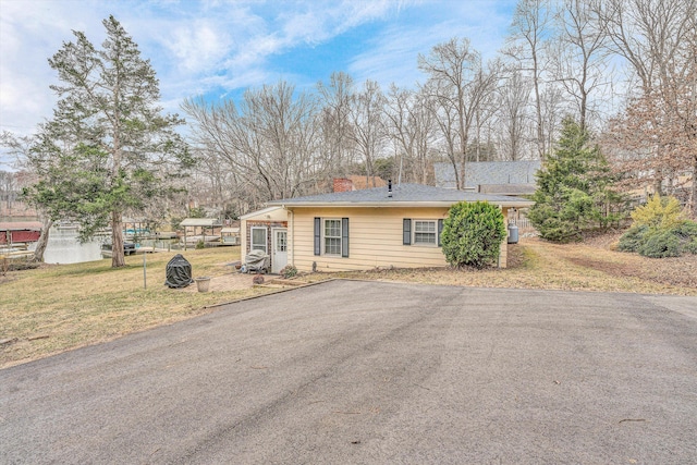 ranch-style house with a front lawn