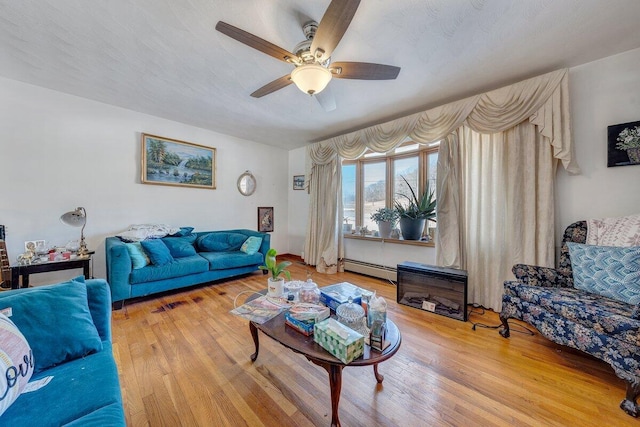 living room featuring a ceiling fan, a baseboard radiator, and wood finished floors