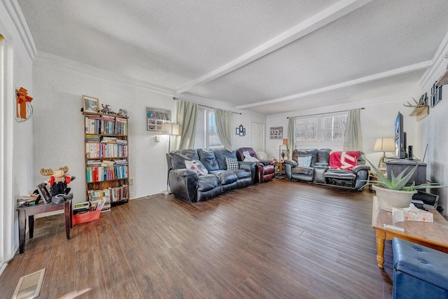 living room featuring visible vents, ornamental molding, wood finished floors, beamed ceiling, and a textured ceiling