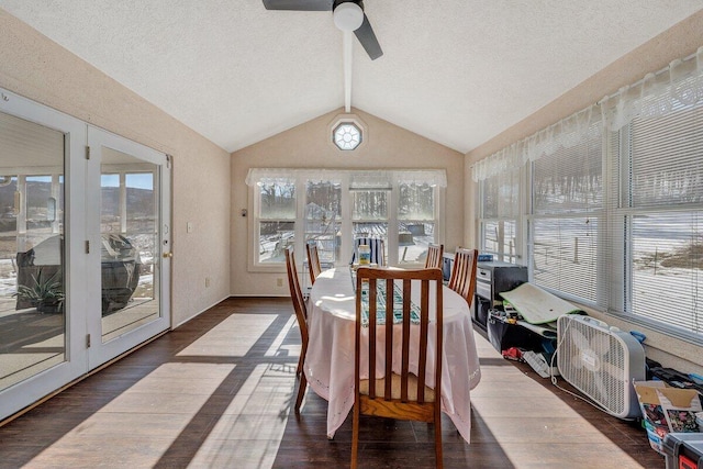 sunroom with lofted ceiling with beams and a ceiling fan