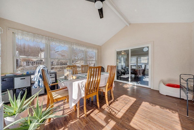 dining room featuring a ceiling fan, lofted ceiling with beams, and wood finished floors