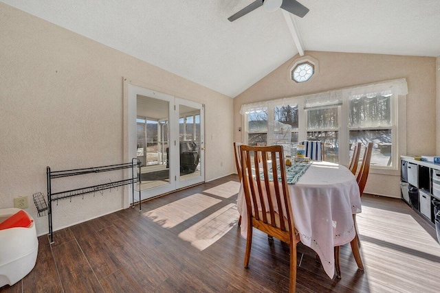 dining room featuring vaulted ceiling with beams, a textured wall, a textured ceiling, ceiling fan, and wood finished floors