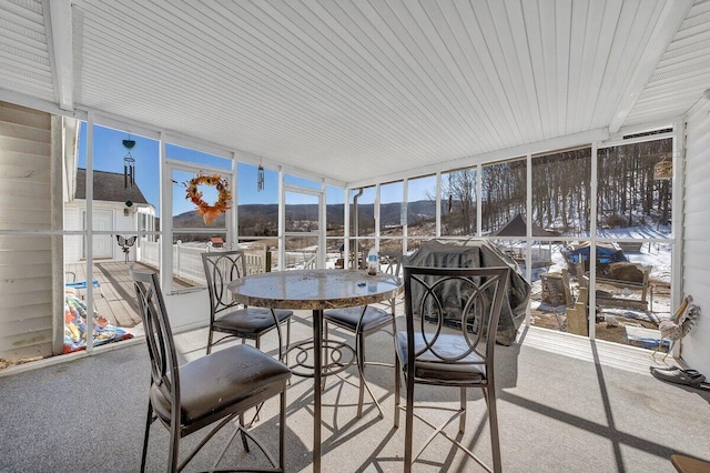 sunroom / solarium featuring a mountain view