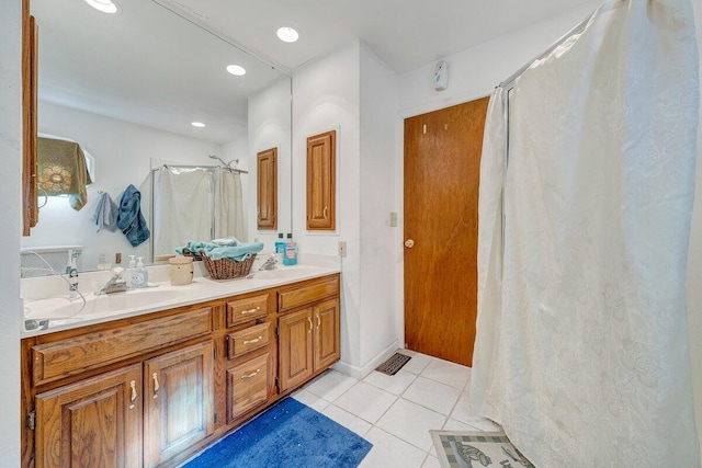 full bathroom with double vanity, visible vents, curtained shower, tile patterned flooring, and a sink